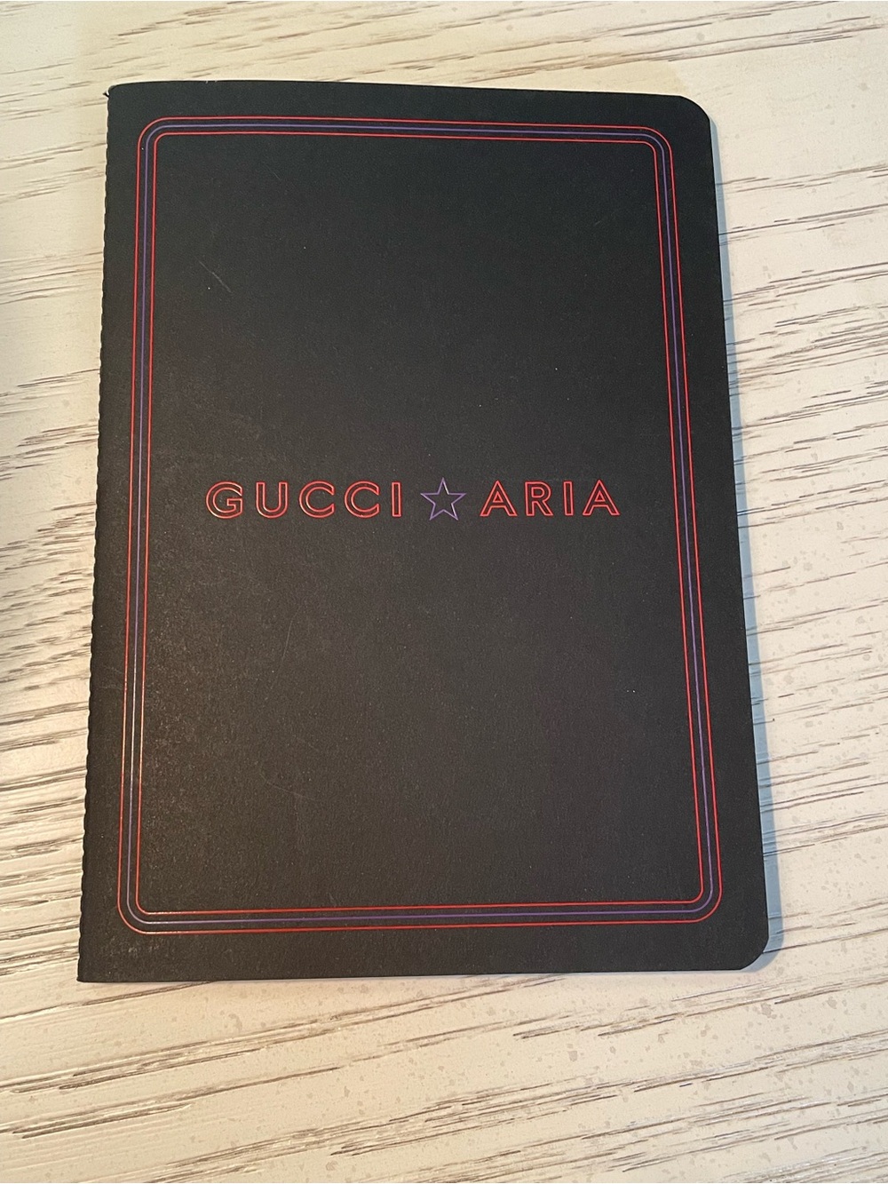 Gucci Aria Black Notebook with Red Trim and Purple Star